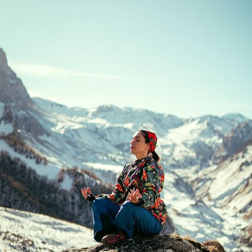 Woman meditating peacefully in a bright, airy space.